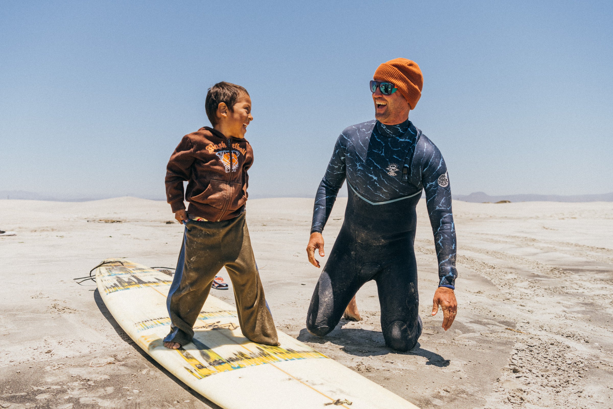 CJ Hobgood teaching a boy to surf