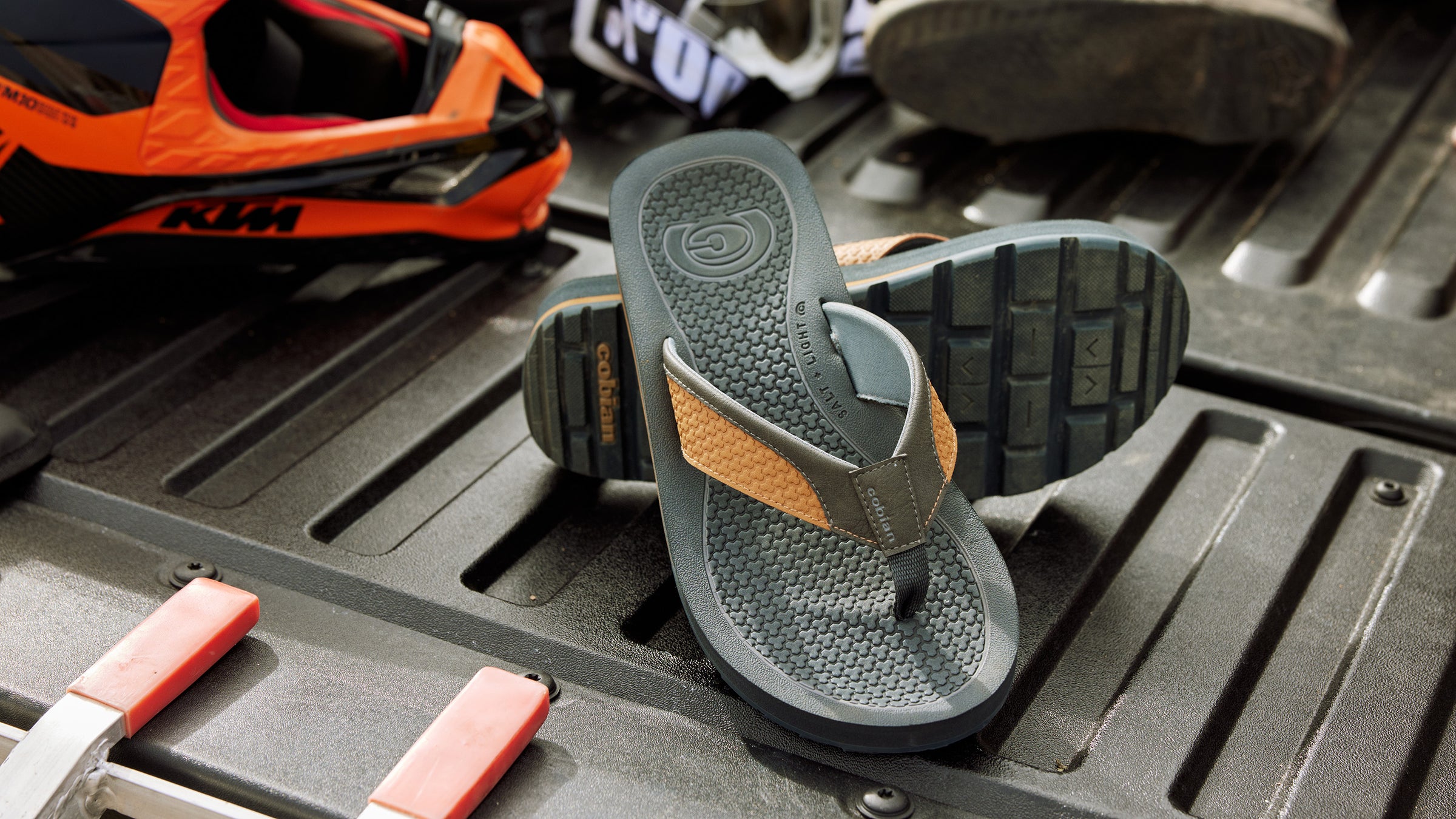 Cobian DRT Sandals in the bed of a pickup truck with motocross gear