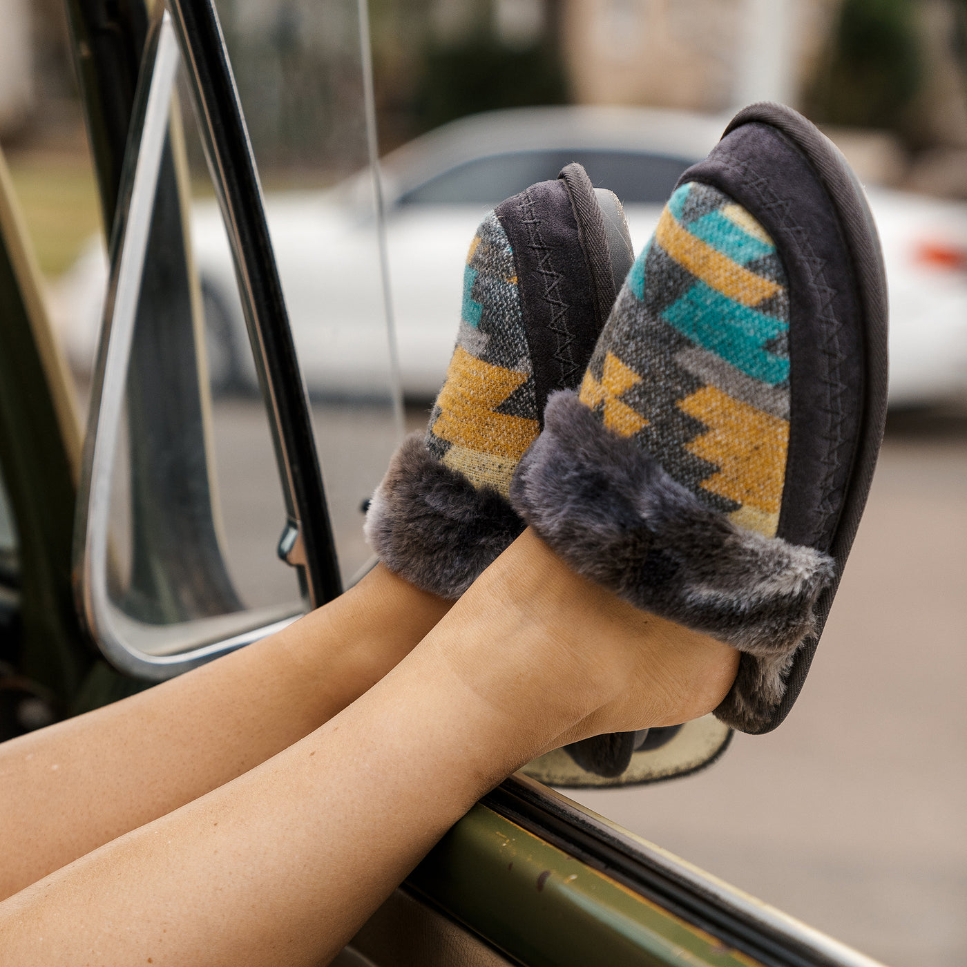 Close up on model kicking back with the Cobian Cheyenne Mule charcoal sticking out of the window of a vintage van #color_charcoal