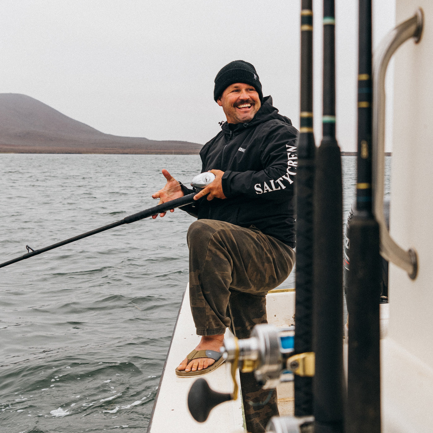 Damien Hobgood wearing the Cobian Draino 3 tan sandal while fishing off a boat #color_tan