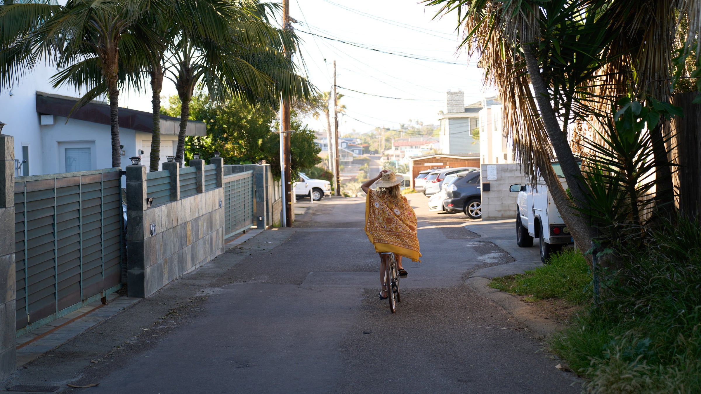 A woman riding away on a bicycle