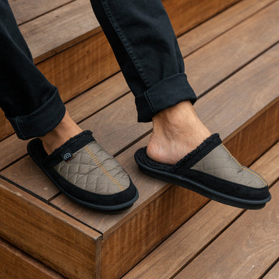 Close up of a man wearing the Cobian Happy Camper Mule Olive  #color_olive