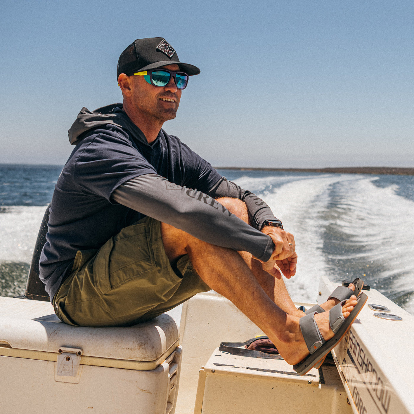 CJ Hobgood wearing the Cobian Odyssey light grey sandal on fishing boat #color_light-grey