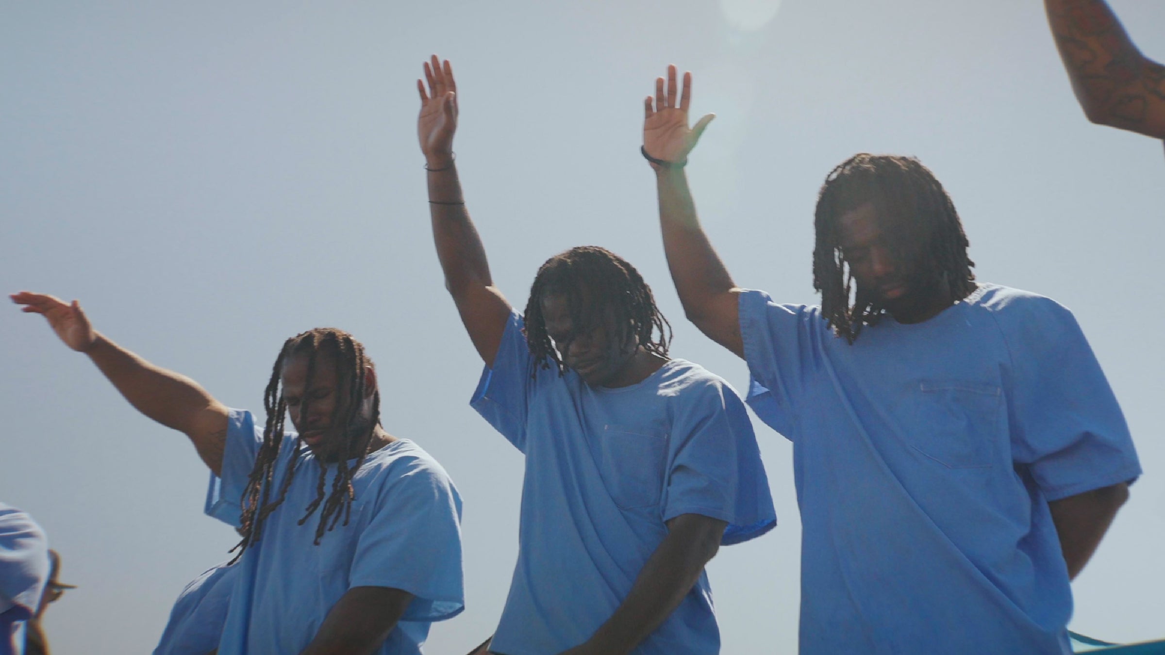 Prisoners lifting their hands in prayer