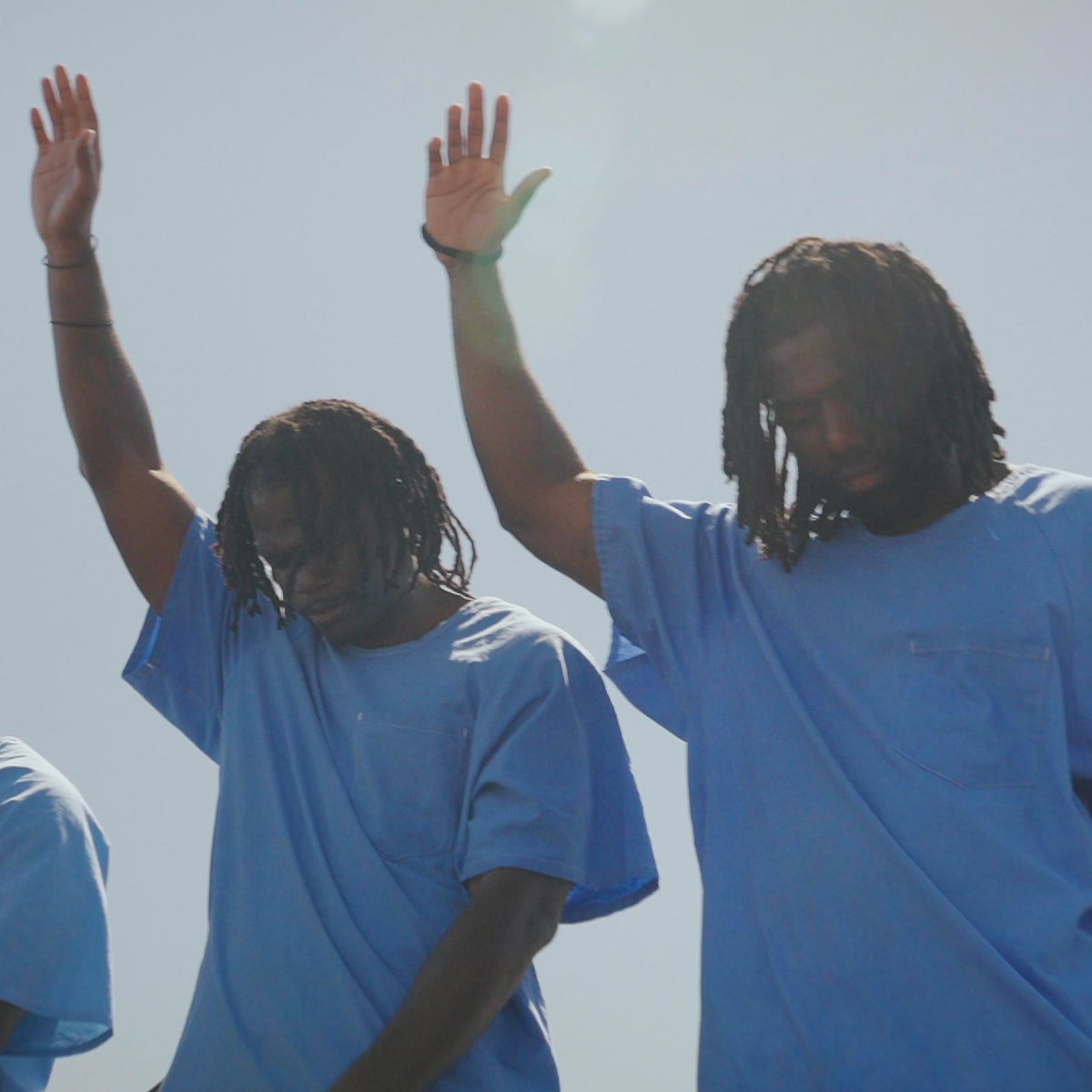 Prisoners lifting their hands in prayer
